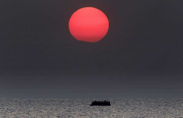 Giannis Behrakis, As the sun rises a dinghy overcrowded with Syrian refugees drifts in the AegeanSsea between Turkey and Greece, Kos 11/8/15, Courtesy Giannis Behrakis/Reuters