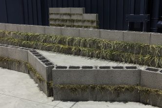 Kishio Suga, Units of Dependency (Detail), 1974-2016, Concrete blocks, grass, Installed dimensions variable, Photo: Agostino Osio, Courtesy of Pirelli HangarBicocca-Milan/Italy & Blum & Poe Gallery