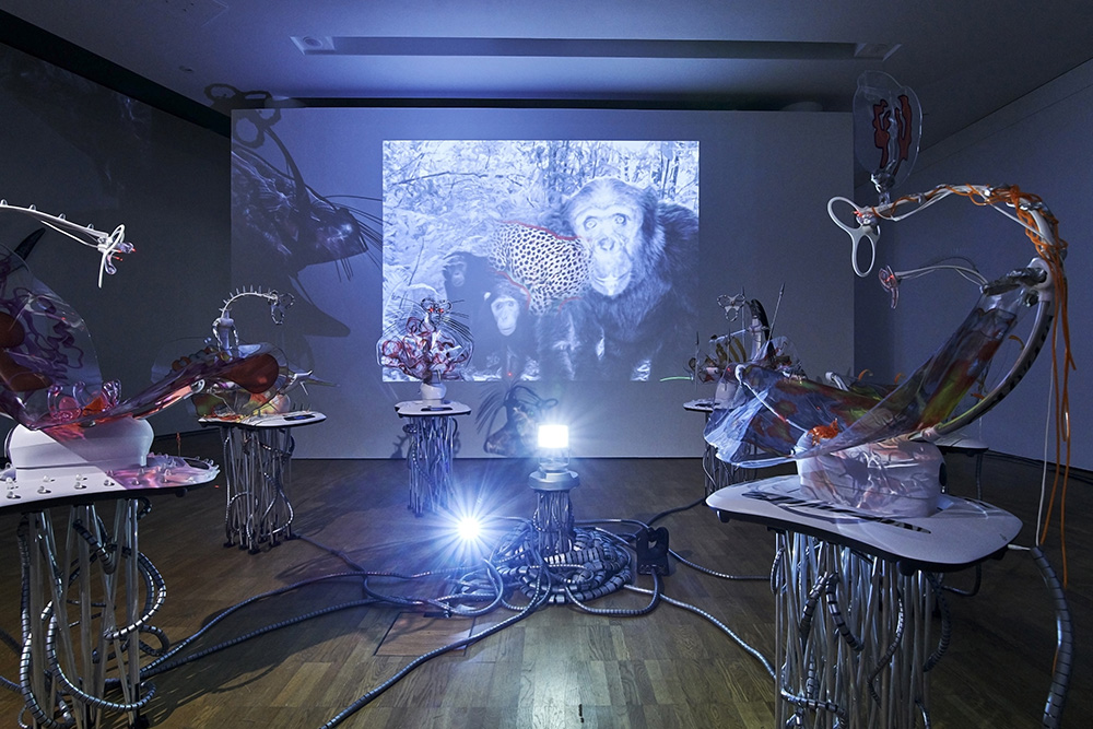 Katja Novitskova, Pattern of Activation (mamaRoo nursery, dawn chorus), 2017, 6 electronic baby swings, 6 aluminium folding stands, plastic hoses, lasers, epoxy clay, digital print, polyurethane resin, robotic bugs, cable ties, plastic toy parts, Swarovski crystals, stress pills, elastic buffers plastic drill plugs, silicon stress eggs, acrylic massagers, animal pattern stickers, fossil, tree mushrooms, power magnets, video projection, Dimensions variable, Courtesy of the artist, Kraupa-Tuskany Zeidler-Berlin, Greene Naftali-New York, Photo: KUMU Art Museum / Tõnu Tunnel, Whitechapel Gallery Archive