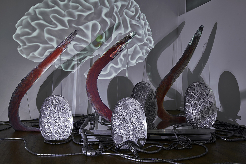 Katja Novitskova, Approximation (C. Elegans, red trio), 2017, 3 digital prints on aluminium, acrylic glass, cut out display, 180 × 300 × 40 cm, Courtesy of the artist, Kraupa-Tuskany Zeidler-Berlin, Greene Naftali-New York, Photo: KUMU Art Museum / Tõnu Tunnel, Whitechapel Gallery Archive