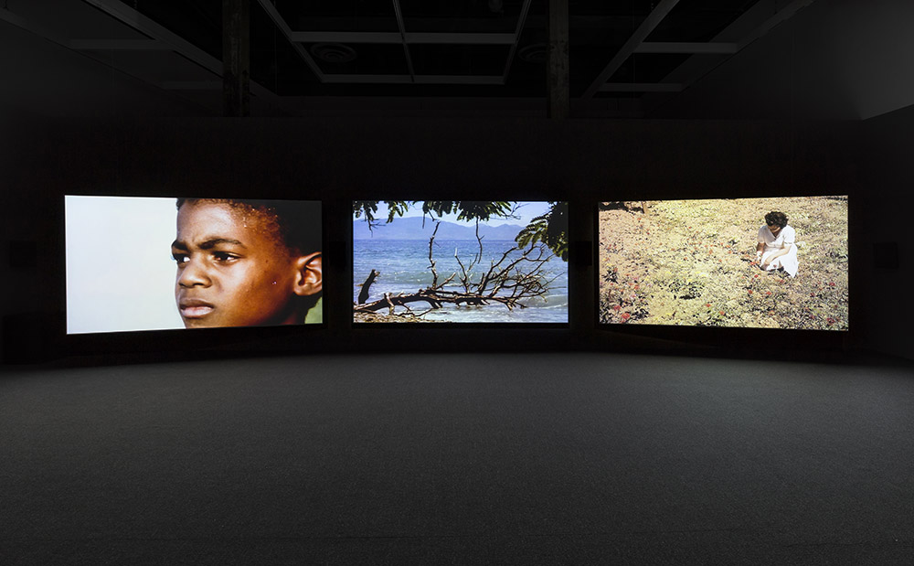 John Akomfrah, The Unfinished Conversation, 2012 (installation view), Three-channel HD video installation, 7.1 sound, color; 45:48 min, © Smoking Dogs Films, Courtesy Lisson Gallery