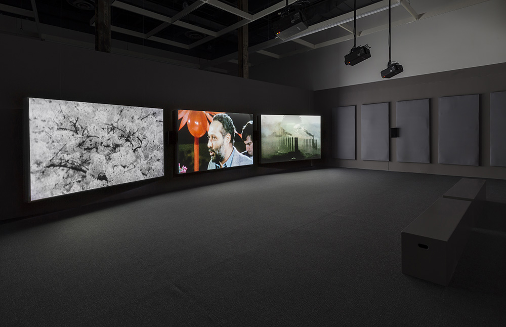 John Akomfrah, The Unfinished Conversation, 2012 (installation view), Three-channel HD video installation, 7.1 sound, color; 45:48 min, © Smoking Dogs Films, Courtesy Lisson Gallery