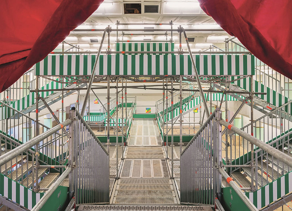 Daniel Buren, Una cosa tira l’altra, 2015-18, Scaffolding, white matt adhesive vinyl 8.7 cm wide on green painted wood, Galleria Continua, © Art Basel
