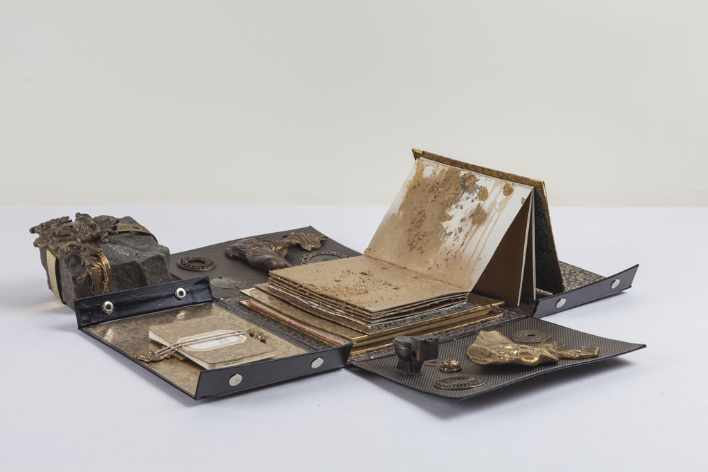 Ricardo Brey, Vienna, 2012, Paper, aged gold metallic paper, metallic objects, coin, bronze objects, stone, wire, two leporello books, one notebook, 17 x 65 x 65 cm, © Ricardo Brey, Courtesy the artist and Alexander Gray Associates