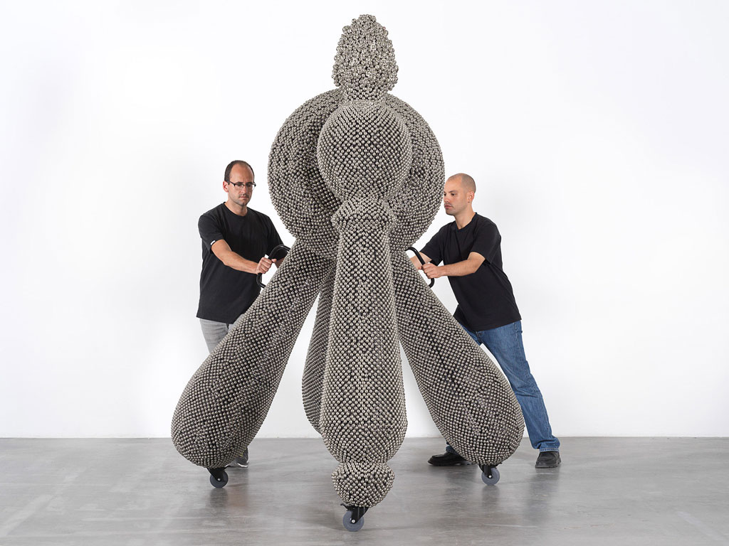 Haegue Yang. Sonic Handles – Law of Three Bodies from the installation Handles. 2019. Powder-coated steel frame, mesh, and handles, casters, nickel-plated bells, and metal rings, 240 × 190 × 265 cm. Commissioned for the Marron Atrium by The Museum of Modern Art, New York. © Haegue Yang and Greene Naftali, New York. Photo: Nick Ash