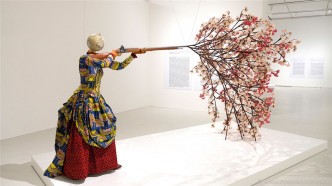 Yinka Shonibare CBE, Woman Shooting Cherry Blossoms, 2019, Unique fibreglass sculpture, Dutch wax printed cotton textile, bespoke hand-coloured globe, steel, brass, zamak, wood, resin, and silk, 244 x 193 x 436 cm, © Yinka Shonibare CBE, All Rights Reserved, DACS/Artimage 2020, Courtesy the artist and Fukuoka City Art Museum