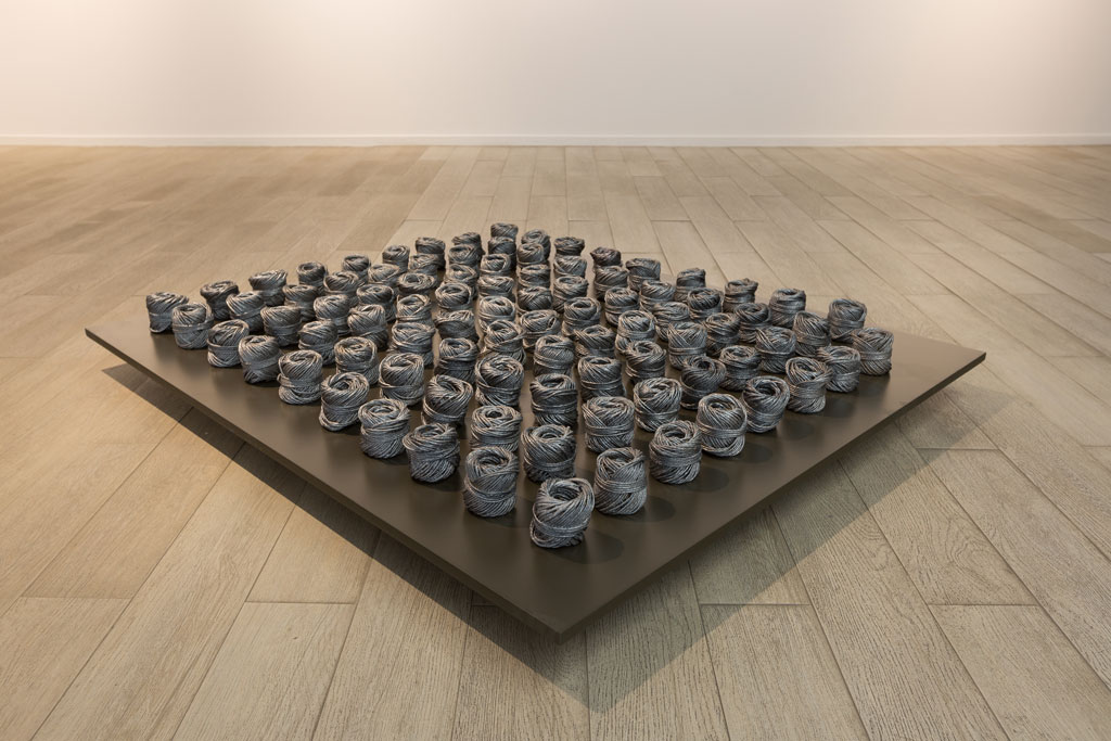 Huda Lutfi, Difficult to Unravel, 2018, 89 flax thread rolls painted in metalic silver, 120 x 100 cm, © Huda Lutfi, Courtesy the artist and third Line Gallery