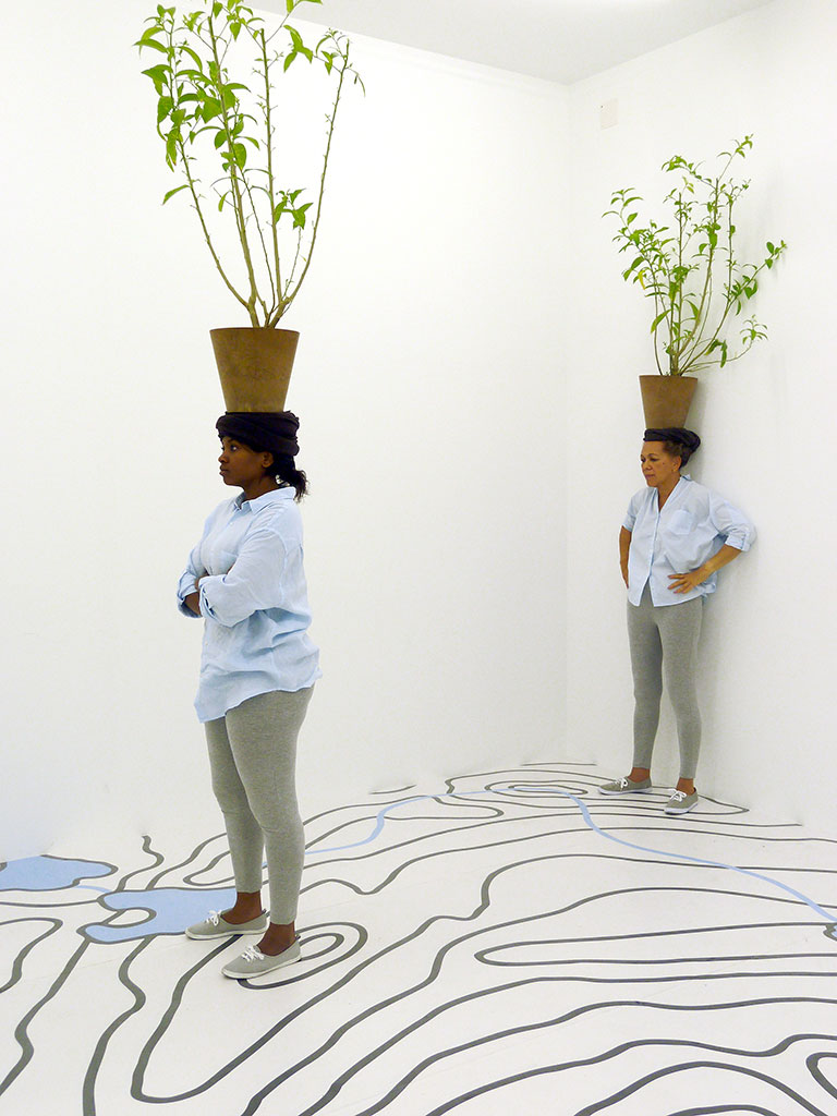 Otobong Nkanga, Diaspore, 2014, Site-specific installation and performance 14 Rooms, Basel, Inkjet-printed topographical map laminated to the floor, Cestrum nocturnum, plant pots, © Otobong Nkanga, photo: Wim van Dongen