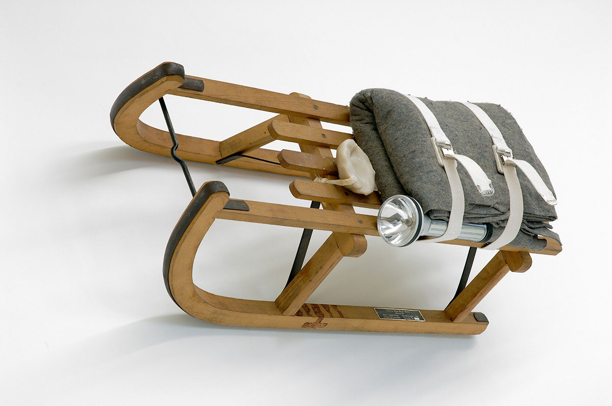 Joseph Beuys, Schlitten (Sled), 1969, wooden sled, felt, belt, flashlight, fat, stamped with oil paint (“Brown Cross”), 35 × 90 × 35 cm, edition of 50 + 5 h. c., unnumbered, not signed, published by Edition Block, Berlin, Sammlung Block, loan to Neues Museum Nürnberg, Nuremberg, © VG Bild-Kunst, Bonn 2021, photo: Uwe Walter, Edition Block, Berlin