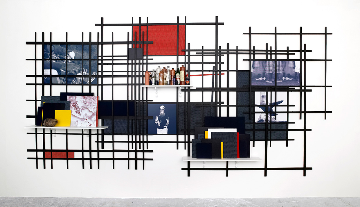 Remy Jungerman, GUARDIAN HAVANA, cotton textile, coconut, shelfs, photo prints, bottles, gin jars, wood, 500 x 250 x 30 cm, 2009. Courtesy the artist and Galerie Ron Mandos. Photography Aatjan Renders