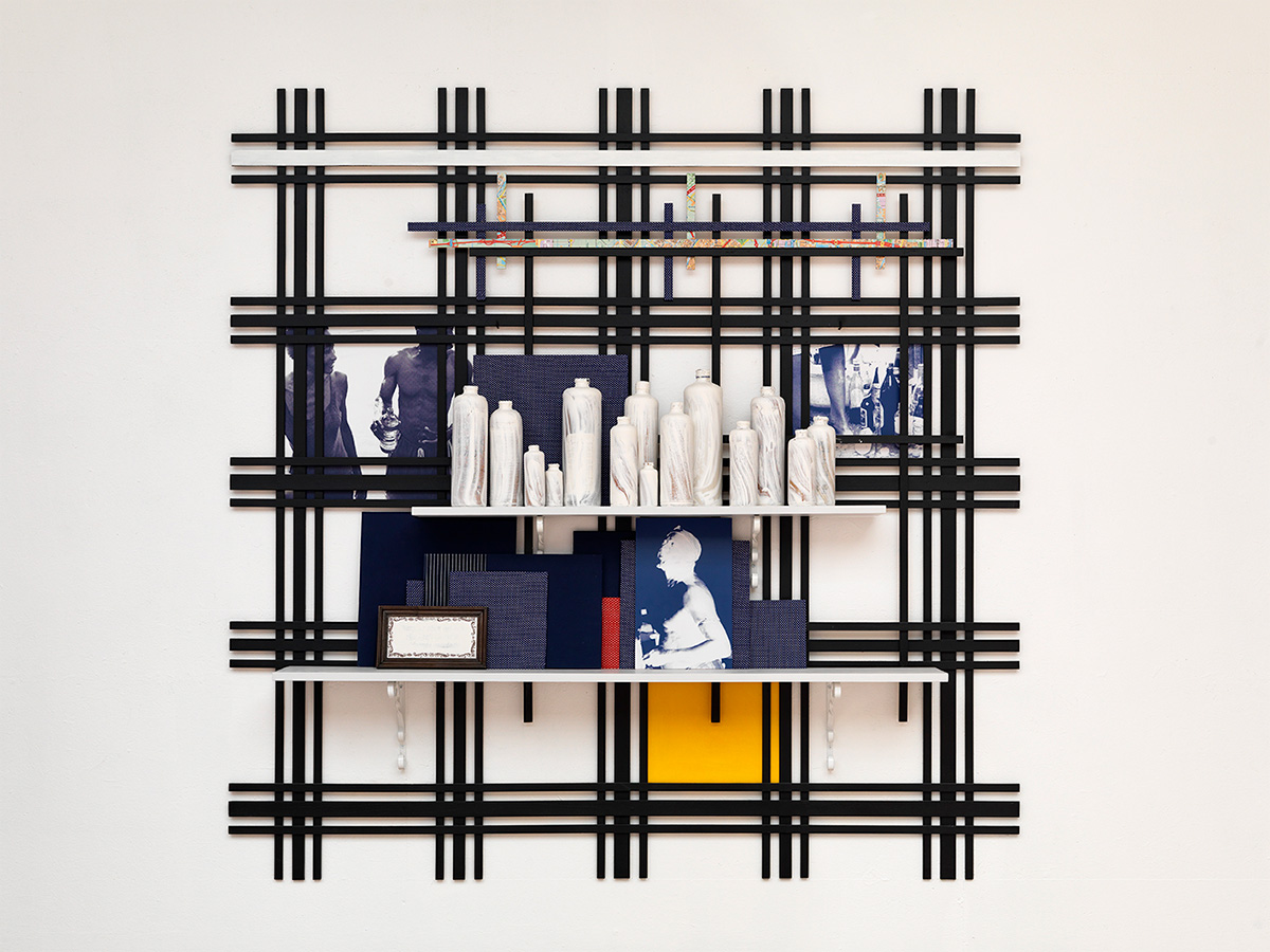 Remy Jungerman, WISE WORDS, cotton textile, kaolin (pimba), gin bottles, photo prints, tile, map, wood, 172 x 173 x 23 cm, 2010. Courtesy the artist and Galerie Ron Mandos. Photography Aatjan Renders