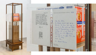 Reinhard Mucha, Material für Dr. Schwarz, 1981/2019, Glass holders, float glass panes, letter copies, solid wood, float glass (exhibition showcase), hardboard and bitumen felt cardboard with oil paint imprint (floor covering, found object) on blockboard (plinth), solid and plywood, floor gliders (2 footstools), 24 packs of Brandt - Der Markenzwieback, 183 × 77 × 49.9cm, Courtesy Sprüth Magers, © muchaArchive / VG Bild-Kunst, Bonn 2022