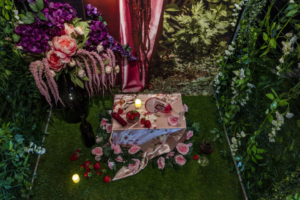 sarah huny young, 7, 2022, mounted archival prints, items of worship, earth, artificial food, flowers, plants, greenery, © & Courtesy the artist