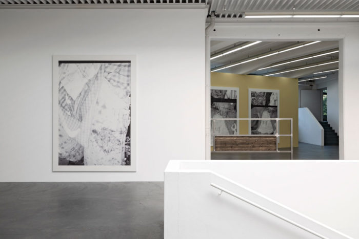 Kelly Tissot, Dubious portrait and improper meeting/Grower, 2022 / Dubious portrait and improper meeting/Schoolgirl I, 2022 / Dubious portrait and improper meeting/Schoolgirl II, 2022, Digital UV print on faux leather, each 290 x 210 cm / Coating against nostalgia/ Cobalt glints II, 2022. Steel, stained fir wood , 300 x 160 x 5 cm, Exhibition view Kunsthaus Baselland 2022. Photo: Gina Folly