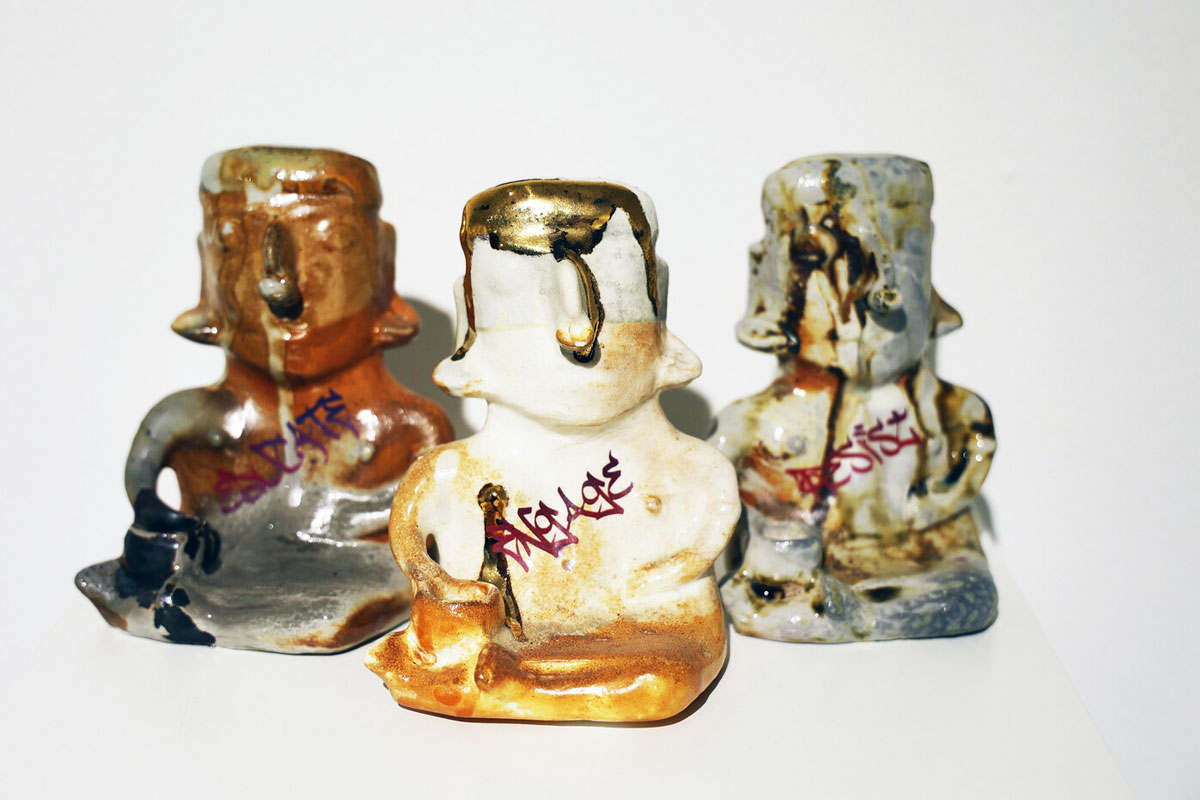 Horacio Rodriguez, Educate, Engage, Resist, 2019. Slip-cast stoneware, glaze, spray enamel, gold luster, 6 x 4 x 3 inches each (3 total). Courtesy of the artist