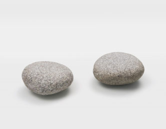 Vija Celmins, Two 1977/2024, One found object and one made object: powder pigment and binder on bronze, with artist’s pedestal, Each: 5½ × 12 × 12 inches; 14 × 31 × 31 cm, © Vija Celmins, Courtesy the artist and Matthew Marks Gallery