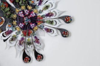 Haegue Yang, Radial Tousled Epiphyte (detail), 2025. 54 3/4 x 54 3/4 x 8 1/4 inches (139 x 139 x 21 cm). Birch plywood, wood stain, acrylic board, powder-coated stainless steel wall mount, stainless steel components, hanji, marbled paper. Courtesy of the artist. Photo by Studio Haegue Yang
