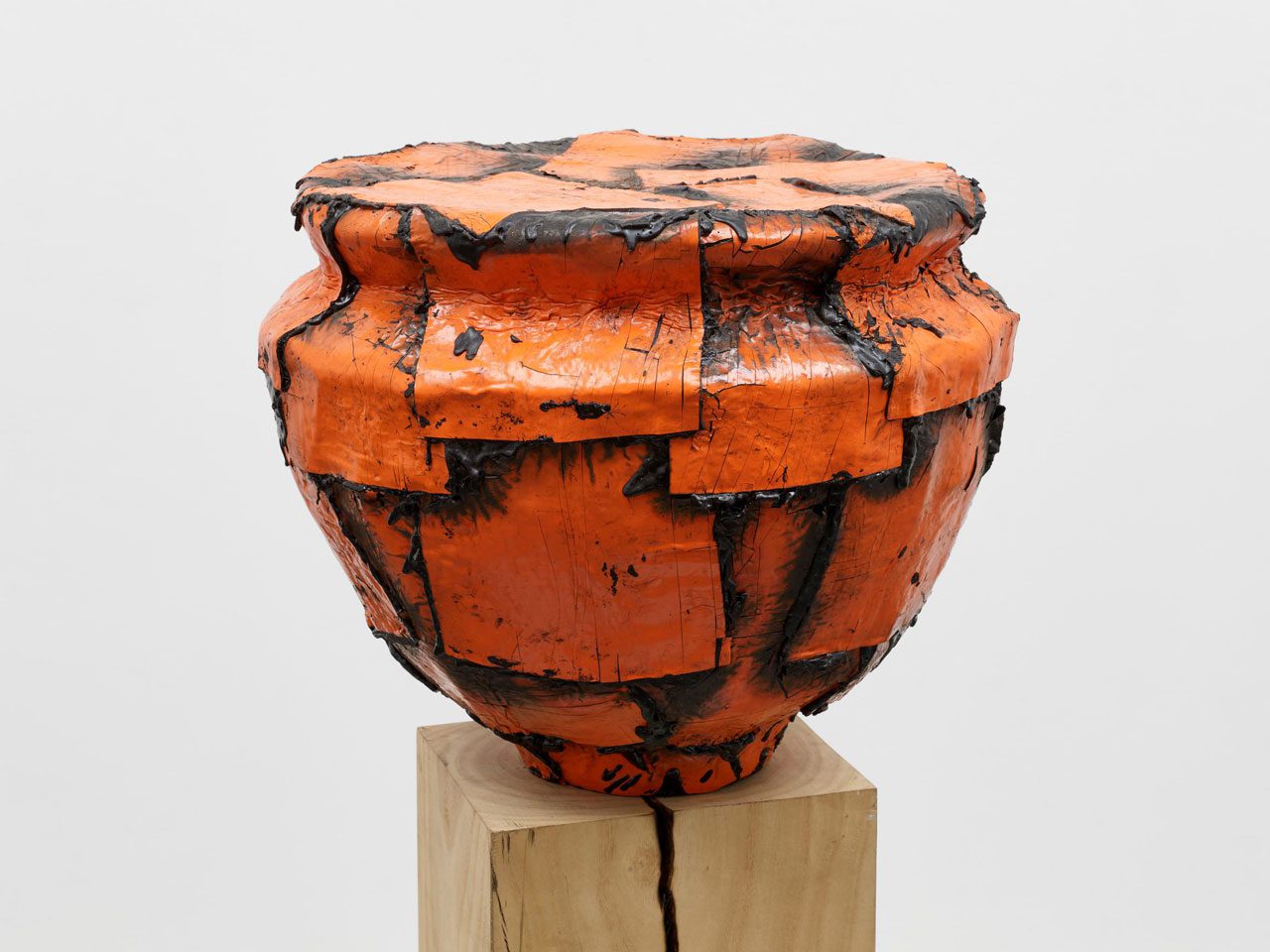 Theaster Gates, Orange Vessel Study, 2024, Wood fired stoneware, rubber torch down and industrial oil-based enamel on ash plinth, Edition 1 of 1, 38 x 44.5 x 44.5 cm |14 15/16 x 17 1/2 x 17 1/2 in., Plinth: 117 x 28.5 x 20 cm | 46 1/16 x 11 1/4 x 7 7/8 in., © Theaster Gates, Courtesy the artist and White Cube Gallery