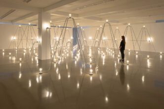 Nancy Holt, Electrical System, 1982 (detail). Steel conduit, lighting and electrical fixtures, light bulbs, electrical wire, and electricity, 55 ft. x 16 ft. x 9 ft. 6 in. Installation view of “Nancy Holt: Light and Language&” at Lismore Castle Arts, Waterford, Ireland, 2021. © Holt/Smithson Foundation / Licensed by Artists Rights Society, New York. Photo: Jed Niezgoda