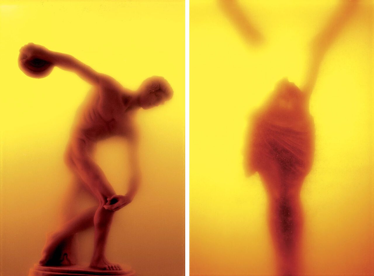 Left: Andres Serrano, Piss Discus (Immersions), 1988, Pigment print, back-mounted on dibond, wooden frame, 165,1 x 114,3 cm (65 x 45 inches), Edition of 4 + 2 AP, © Andres Serrano, Courtesy the artist and Galerie Nathalie ObadiaRight: Andres Serrano, Winged Victory (Immersions), 1987 , Pigment print, back-mounted on dibond, wooden frame, 114,3 x 83,2 cm (45 x 32 3/4 inches), Edition of 10 + 2 AP, © Andres Serrano, Courtesy the artist and Galerie Nathalie Obadia 