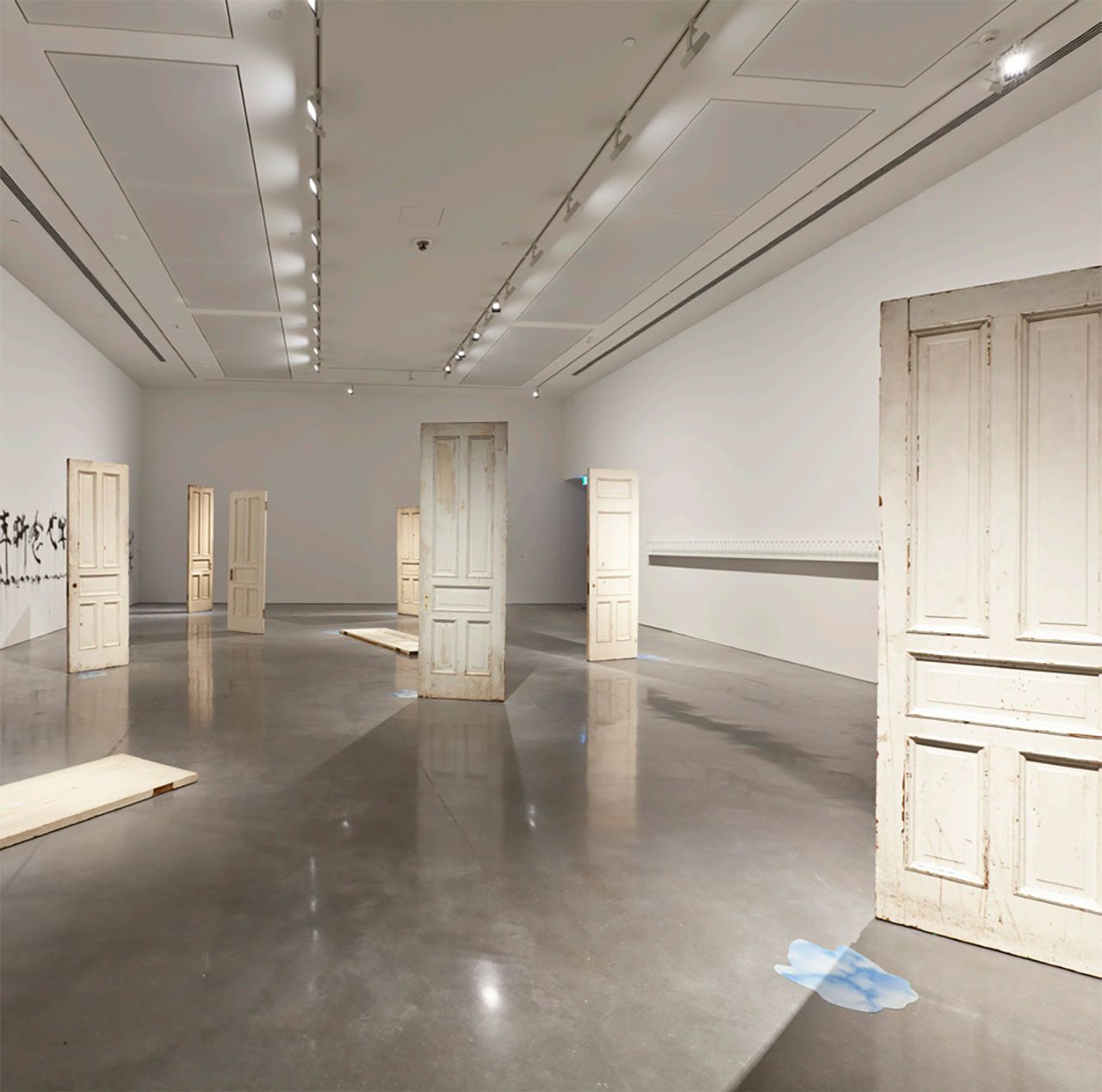 Yoko Ono, DOORS, 2011, Installation, 9 antique wooden doors with artist’s handwritten inscriptions 262 x 84 x 8 cm each, © Yoko Ono, Courtesy the artist and MUSAC (Museo de Arte Contemporaneo de Castilla y Leon)