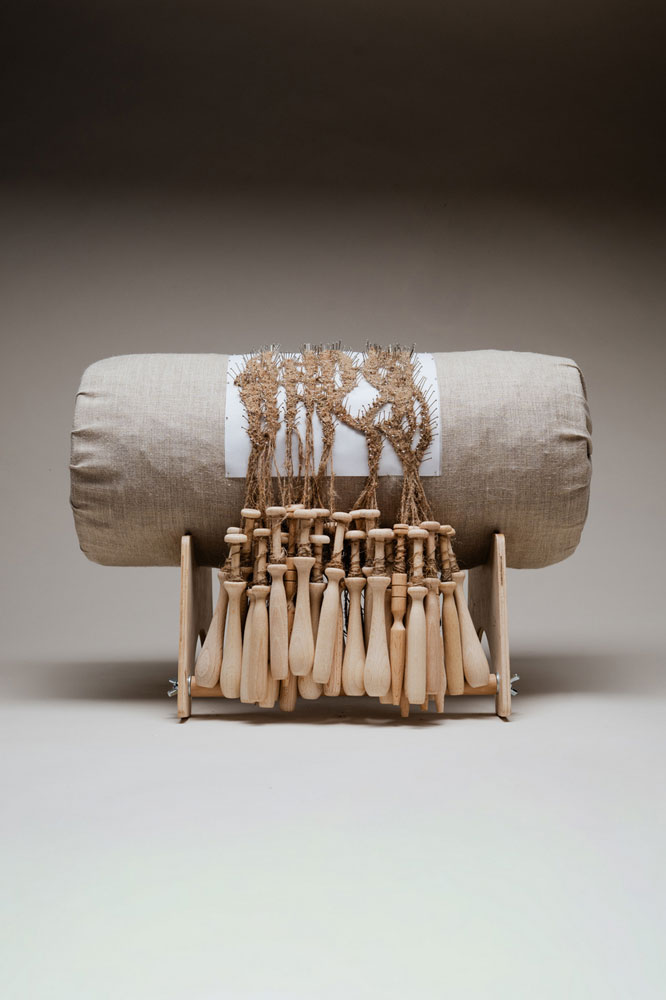 Agnieszka Polkowska, Formative Forces, 2025, Wild hop fibre lace and fibre stages, metal pins, wooden board, a roll filled with hay and wrapped in linen fabric, metal wing nuts, 560x560mm© Photo: Peter Oliver Wolff