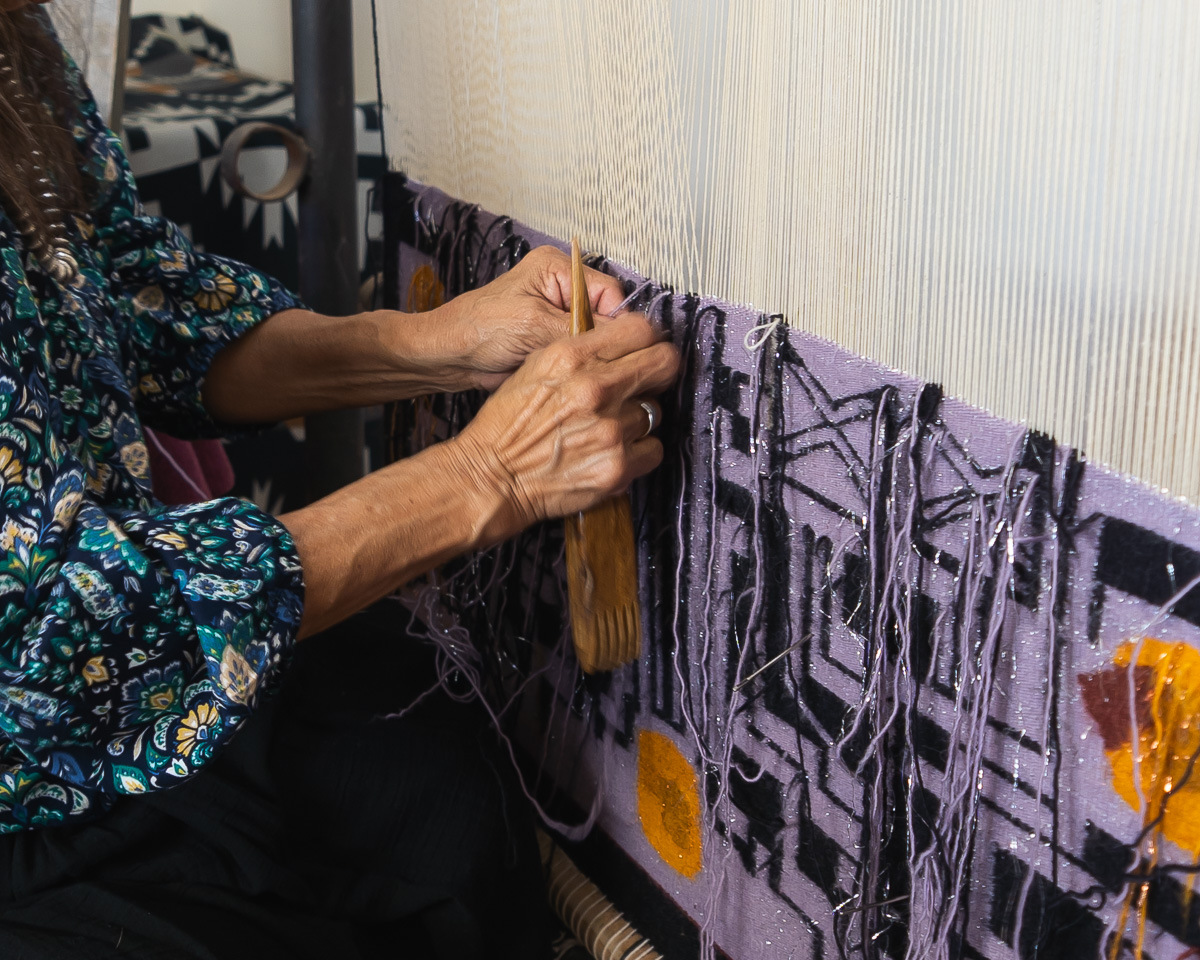 Marilou Schultz weaving Geo XX Diné Computer Chip Weaving, 2026, Photo Credit: Gabby Usinger