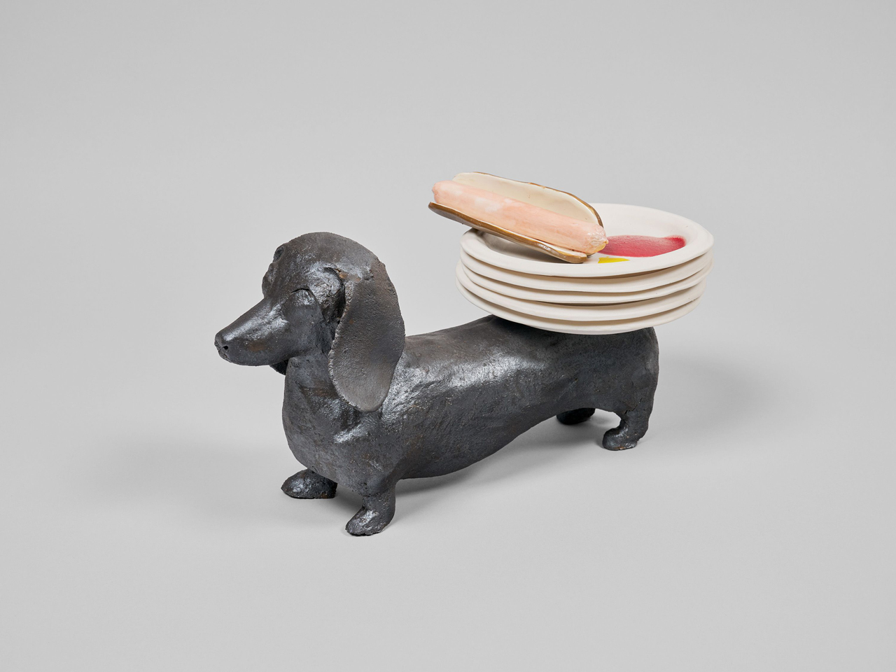 Sonia Boyajian, Weiner Dog & Organic Hot Dogs, 2026, Terracotta and porcelain with multicolor glaze, Overall dimensions variable, © Sonia Boyajian, courtesy the artist and David Zwirner Gallery