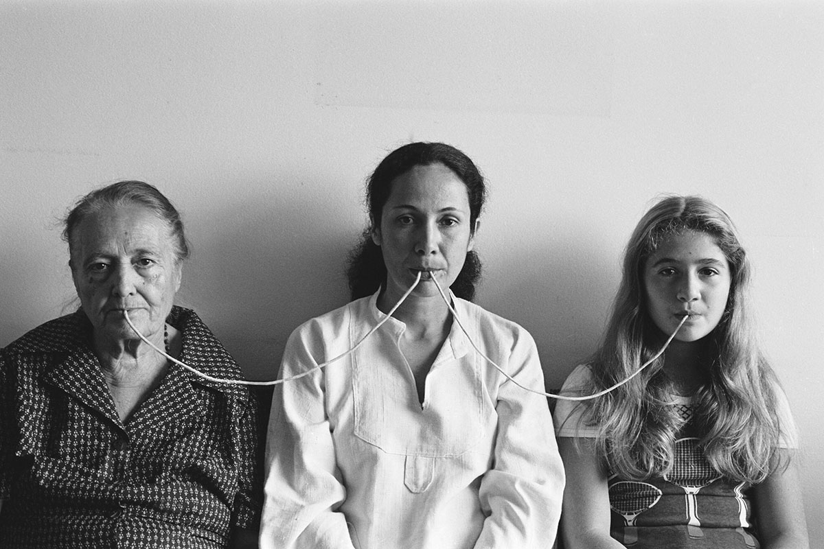 Anna Maria Maiolino, Por um fio (By a Thread), from Fotopoemação (Photopoemaction) series, 1976/2017, Black and white analog photograph, Edition 4/5 + 2 AP, 44 x 65 cm / 17 3/8 x 25 5/8 inches 59.1 x 79.4 x 4.1 cm / 23 1/4 x 31 1/4 x 1 5/8 inches (framed), © Anna Maria Maiolino, Photo: Regina Vater, Courtesy the artist and Hauser & Wirth Gallery