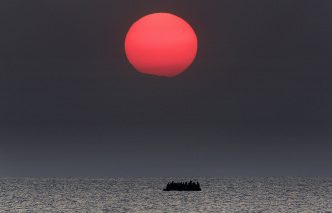 Giannis Behrakis, As the sun rises a dinghy overcrowded with Syrian refugees drifts in the AegeanSsea between Turkey and Greece, Kos 11/8/15, Courtesy Giannis Behrakis/Reuters