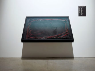 Santiago Sierra, National Flag Of Spain Submerged In Blood, 2021, Silk, blood, 135 x 133 x 100 cm (display), 111 x 2 x 81 cm (flag), © Santiago Sierra, Courtesy the artist and KOW