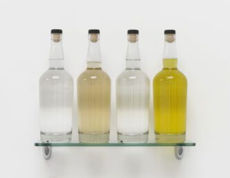 Nayland Blake, Water/Wine/Vinegar/Piss 1987/2025, Water, wine, vinegar, urine, glass, stoppers, and hardware, 11½ × 15½ × 4⅞ inches; 29 × 39 × 12 cm, © Nayland Blake, Courtesy the artist and Matthew Marks Gallery