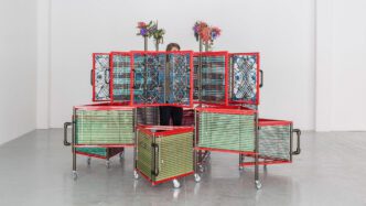 Haegue Yang, Dress Vehicle – Yin Yang, 2012. Aluminum venetian blinds, powder-coated aluminum frame, powder-coated handles, casters, magnets, knitting yarn, bells, elastic cord. 221 x 310 x 310 cm. Collection of M+, Hong Kong. Installation view of Haegue Yang: Ajar, La Douane, Galerie Chantal Crousel, Paris, France, 2012. Photo: Florian Kleinefenn