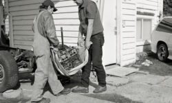 Jeff_Wall_Men_move_an_engine_block