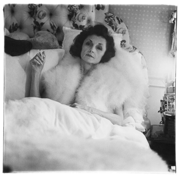 Diane Arbus , Brenda Diana Duff Frazier, 1938 Debutante of the Year, at home, Boston, Mass. 1966, 1966, Gelatin silver print, Image: 14 3/8 x 14 3/4 inches (36.5 x 37.5 cm), Sheet: 20 x 16 inches (50.8 x 40.6 cm), Framed: 24 3/4 x 20 3/4 inches (62.9 x 52.7 cm), Edition of 75 , © The Estate of Diane Arbus, Printed by Neil Selkirk, Signed verso in ink by Doon Arbus for the Estate of Diane Arbus; estate stamp verso, Courtesy Estate of Diane Arbus and Fraenkel Gallery
