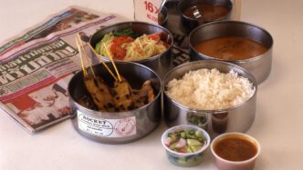 Rirkrit Tiravanija, untitled (lunch box) [Detail], 1996, Stainless steel container, Thai newspaper and Thai meal, 31.5 x 16 x 18 cm. © Rirkrit Tiravanija. Image courtesy of 1301PE